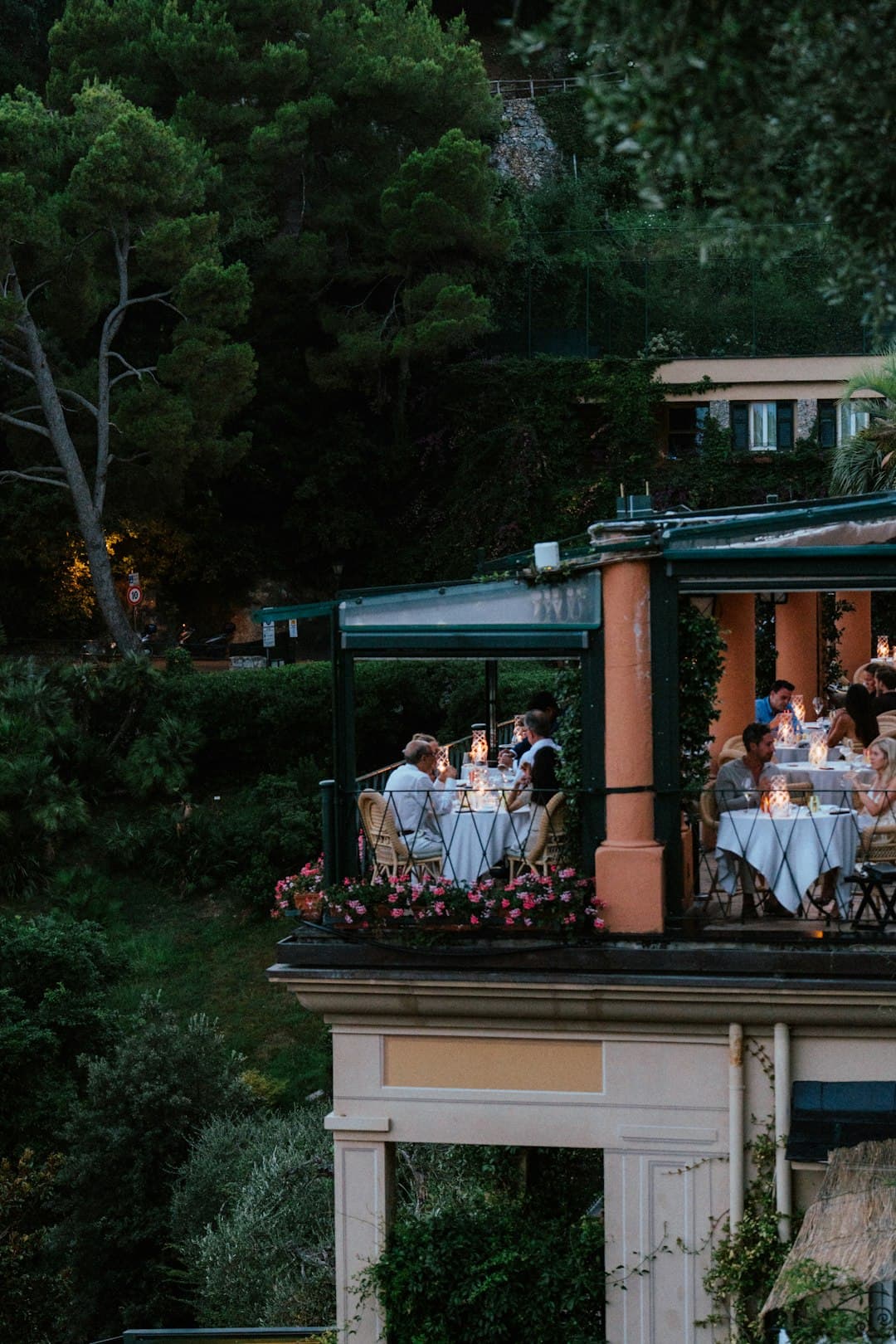 People dining on a balcony at dusk